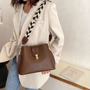 Vegan leather handbag, with woven herringbone design strap.